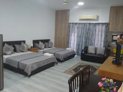a living room with two beds and a desk at Maytower Studio in Kuala Lumpur