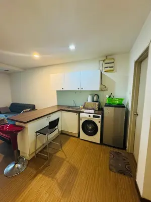 a small kitchen with a sink and a stove at Residence HomeStay in Kuala Lumpur