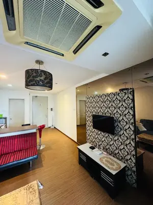 a living room with a couch and a tv at Residence HomeStay in Kuala Lumpur
