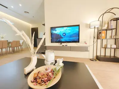 a living room with a television and a plate of food at Weekly Monthly Stay - Bangsar Trade Centre Aspire in Kuala Lumpur