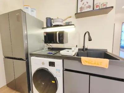 a kitchen with a washing machine and a sink at Weekly Monthly Stay - Bangsar Trade Centre Aspire in Kuala Lumpur