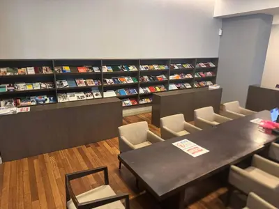 a room with a table and chairs and books at Elevated Horizons Hostel & Infinity Suites Skypool in Kuala Lumpur