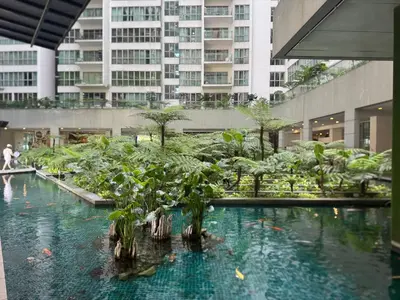 a large pool of water with trees in a building at Elevated Horizons Hostel & Infinity Suites Skypool in Kuala Lumpur