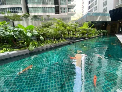 a swimming pool in the middle of a building at Elevated Horizons Hostel & Infinity Suites Skypool in Kuala Lumpur