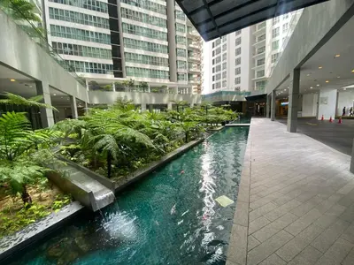 a large building with a pool of water in a building at Kuala Lumpur Infinity Skypool hostel in Kuala Lumpur
