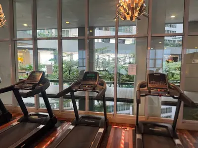 a gym with two treadmills in a building at Kuala Lumpur Infinity Skypool hostel in Kuala Lumpur