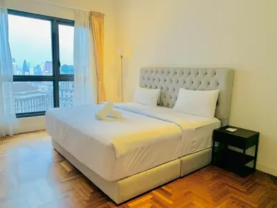 a bedroom with a large bed with a large window at The MEWS KLCC By Arman in Kuala Lumpur