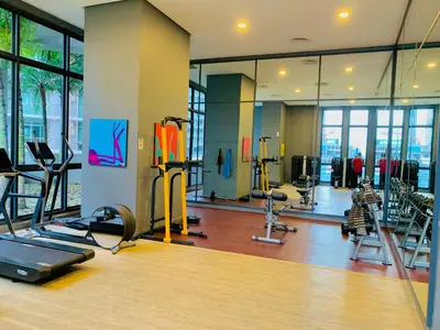 a gym with treadmills and machines in a room at The Mews KLCC By SKY GARDEN in Kuala Lumpur