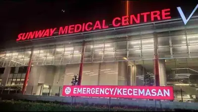 a building with a red sign in front of it at 2Room 8pax Link to Velocity Mall MRT KL in Kuala Lumpur