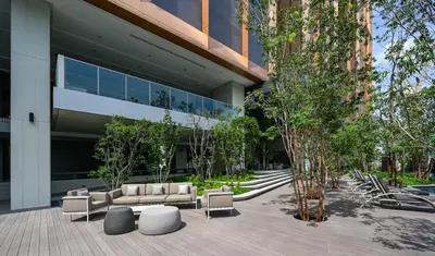 a building with couches and trees in front of it at Lucentia Residences by Luxe Suites in Bukit Bintang KLCC! in Kuala Lumpur