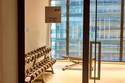 a row of benches in a room with windows at 03 Tribeca Serviced Suites I 5 min to Pavilion KL I 2R1B I TRX Tower View in Kuala Lumpur