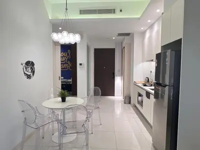 a kitchen with a table and chairs and a refrigerator at 03 Tribeca Serviced Suites I 5 min to Pavilion KL I 2R1B I TRX Tower View in Kuala Lumpur