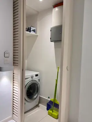 a small laundry room with a washer and dryer at 03 Tribeca Serviced Suites I 5 min to Pavilion KL I 2R1B I TRX Tower View in Kuala Lumpur