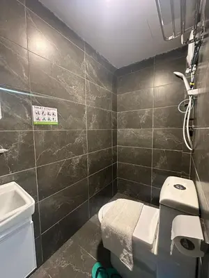 a bathroom with a toilet and a sink at SS GREY INN Jalan bukit bintang in Kuala Lumpur