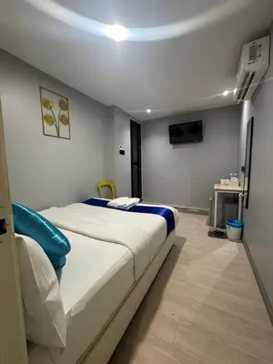 a bedroom with a large white bed in a room at SS GREY INN Jalan bukit bintang in Kuala Lumpur
