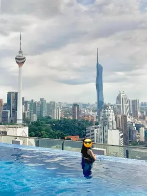 a person in a swimming pool on top of a building at XING LUN KLCC The Colony Infinitum in Kuala Lumpur