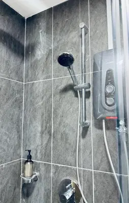 a shower in a bathroom with a phone on the wall at XING LUN KLCC The Colony Infinitum in Kuala Lumpur