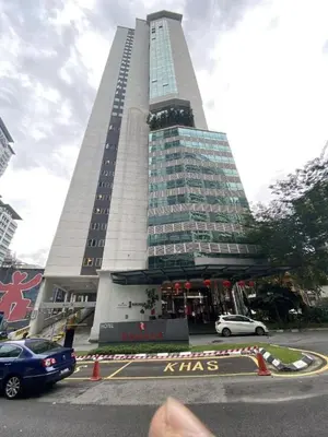 a tall building with cars parked in front of it at One Ceylon Suites By OHaus in Kuala Lumpur