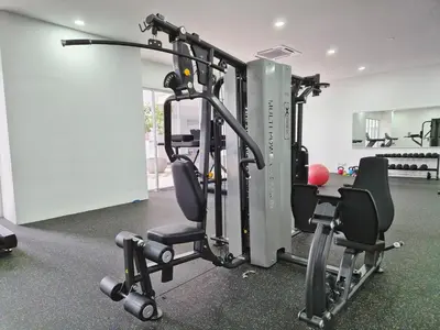 a gym with a treadmill and two chairs in a room at D3911 Klcc View Private Roof Terrace l 8Pax in Kuala Lumpur
