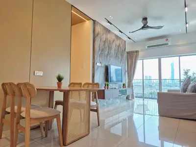 a living room with a wooden table and chairs at D3911 Klcc View Private Roof Terrace l 8Pax in Kuala Lumpur