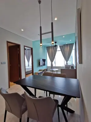 a dining room with a table and chairs at Sky Suites KLCC by Deep Sleep in Kuala Lumpur