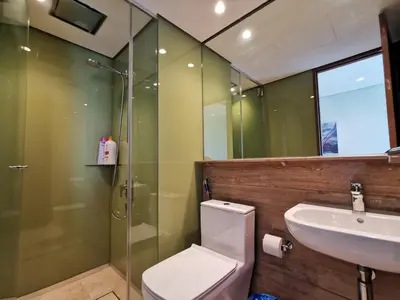 a bathroom with a toilet and a sink and a shower at Sky Suites KLCC by Deep Sleep in Kuala Lumpur