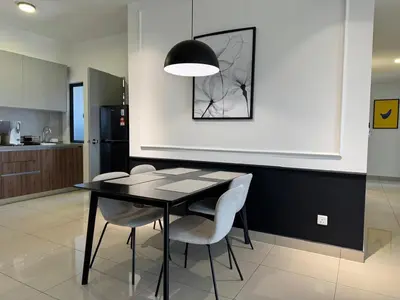 a dining room with a black table and chairs at M Vertica E33A10 l 4 Bedroom l 8 Pax in Kuala Lumpur