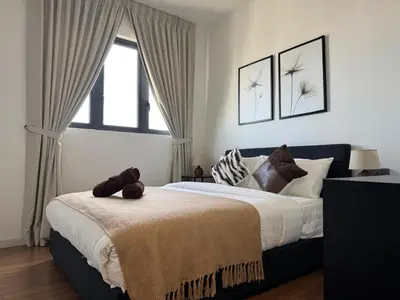 a bedroom with a large bed and a window at M Vertica E33A10 l 4 Bedroom l 8 Pax in Kuala Lumpur