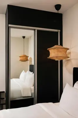 a bedroom with a mirror and a bed at BRYQS Hotel KL Sentral in Kuala Lumpur