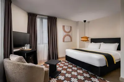 a hotel room with a large bed and a chair at BRYQS Hotel KL Sentral in Kuala Lumpur