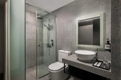 a bathroom with a toilet and a sink and a shower at BRYQS Hotel KL Sentral in Kuala Lumpur