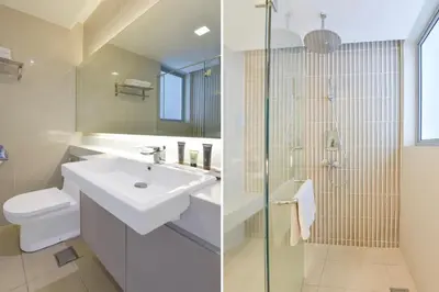 a bathroom with a sink and a shower and a toilet at Sunday Hotel Near Petronas Twin Tower Formerly Suasana Suites in Kuala Lumpur