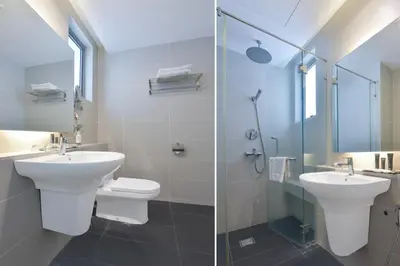 a bathroom with a toilet and a sink and a shower at Sunday Hotel Near Petronas Twin Tower Formerly Suasana Suites in Kuala Lumpur