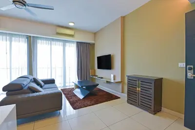 a living room with a couch and a flat screen tv at Sunday Hotel Near Petronas Twin Tower Formerly Suasana Suites in Kuala Lumpur
