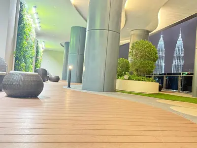 a lobby with a floor of plants and a building at Eaton Residences KLCC By ARBAN in Kuala Lumpur