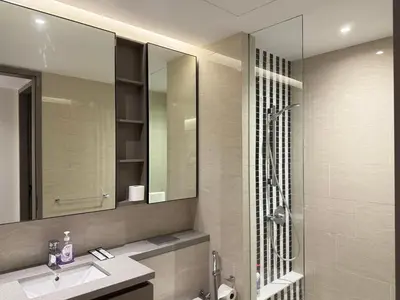 a bathroom with a shower and a sink and a mirror at Eaton Residences KLCC By ARBAN in Kuala Lumpur