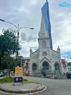 a large white church with a clock tower on a street at The Robertson Bukit Bintang KLCC by Dream'Inn in Kuala Lumpur