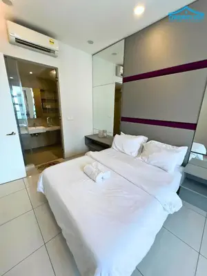 a large white bed with two towels on top of it at The Robertson Bukit Bintang KLCC by Dream'Inn in Kuala Lumpur