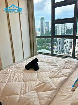 a stuffed animal laying on a bed in a room with a window at The Robertson Bukit Bintang KLCC by Dream'Inn in Kuala Lumpur