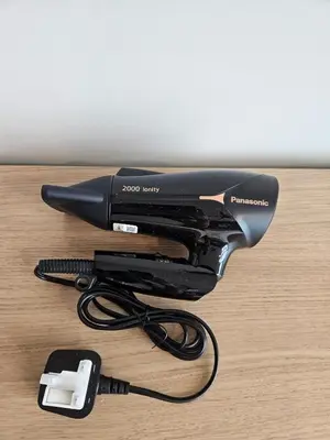 a black hair dryer sitting on top of a table at Sky Suites KLCC Level 58 in Kuala Lumpur