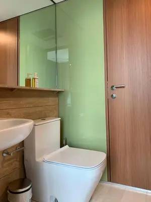 a bathroom with a toilet and a sink and a mirror at Sky Suites KLCC Level 58 in Kuala Lumpur