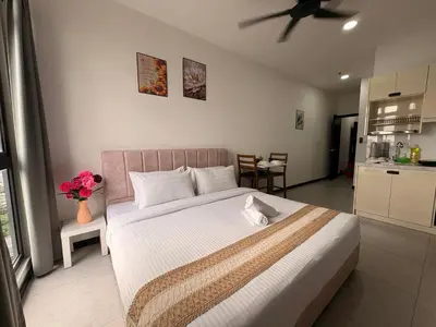 a bedroom with a large bed and a kitchen at Luxury Studio - City View - LRT - KLCC - KL - Gleneagles in Kuala Lumpur