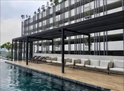 a building with chairs and a pool of water at Vivo Suite 4 pax 2 bed Studio in Kuala Lumpur