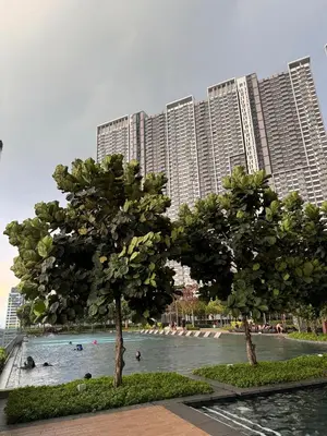 a swimming pool in front of a large building at RoomBnB MVertica in Kuala Lumpur