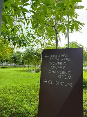 a sign in front of a tree in a park at RoomBnB MVertica in Kuala Lumpur