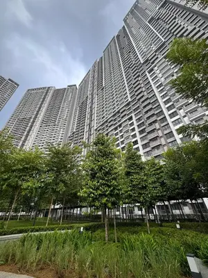 a tall building with trees in front of it at RoomBnB MVertica in Kuala Lumpur