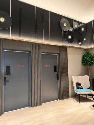 a room with four doors and a chair and a speaker at RoomBnB MVertica in Kuala Lumpur