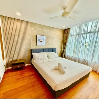 a bedroom with a large bed with a ceiling fan at Sky suites klcc by Elham in Kuala Lumpur