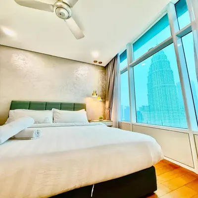 a bedroom with a large bed and a large window at Sky suites klcc by Elham in Kuala Lumpur