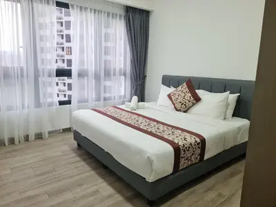 a bedroom with a large bed in front of a window at Agile Residence Service Suites Bukit Bintang KL in Kuala Lumpur